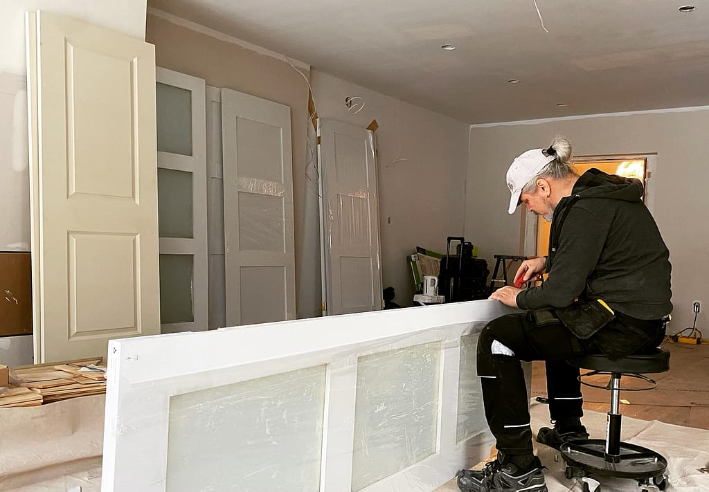 Finish carpenter Jack at Wood Job Finish Carpentry preparing a door for installation
