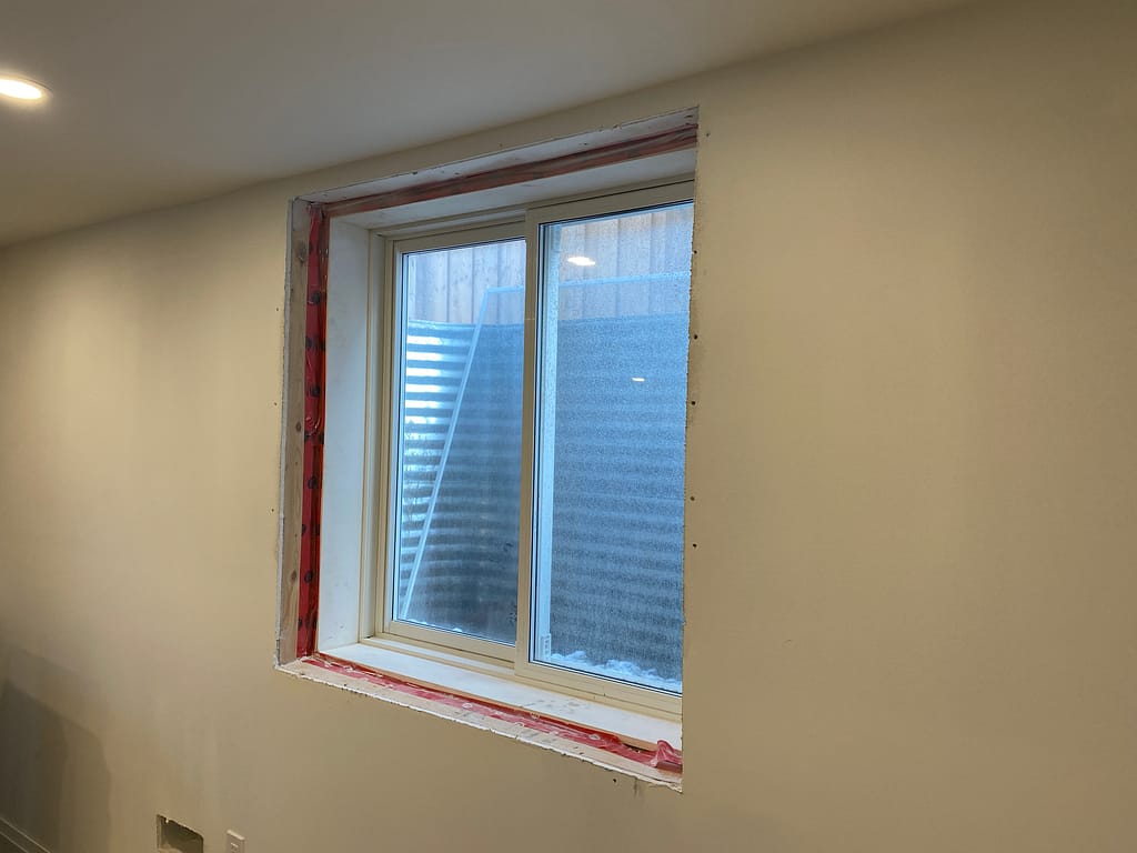 Unfinished window frame in basement