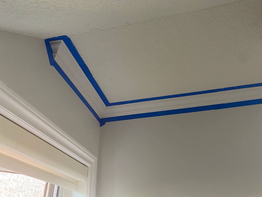 Close-up of crown moulding finished at a sloped stair opening