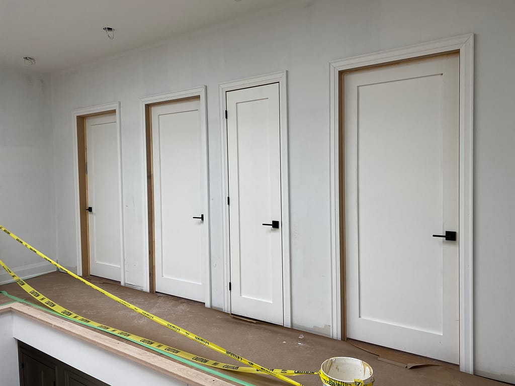 Full house interior door installation with matching casing in an Oakville custom home