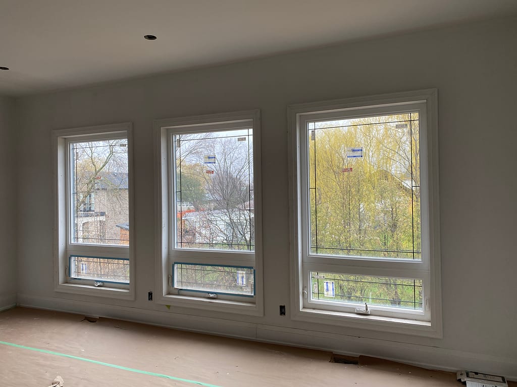 Window casing and baseboard installation in an Oakville custom home