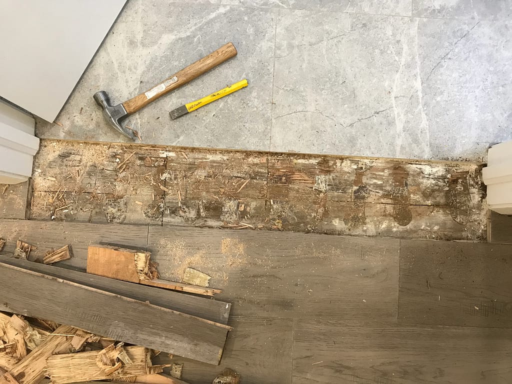 Damaged engineered hardwood planks removed for a flooring repair in Mississauga