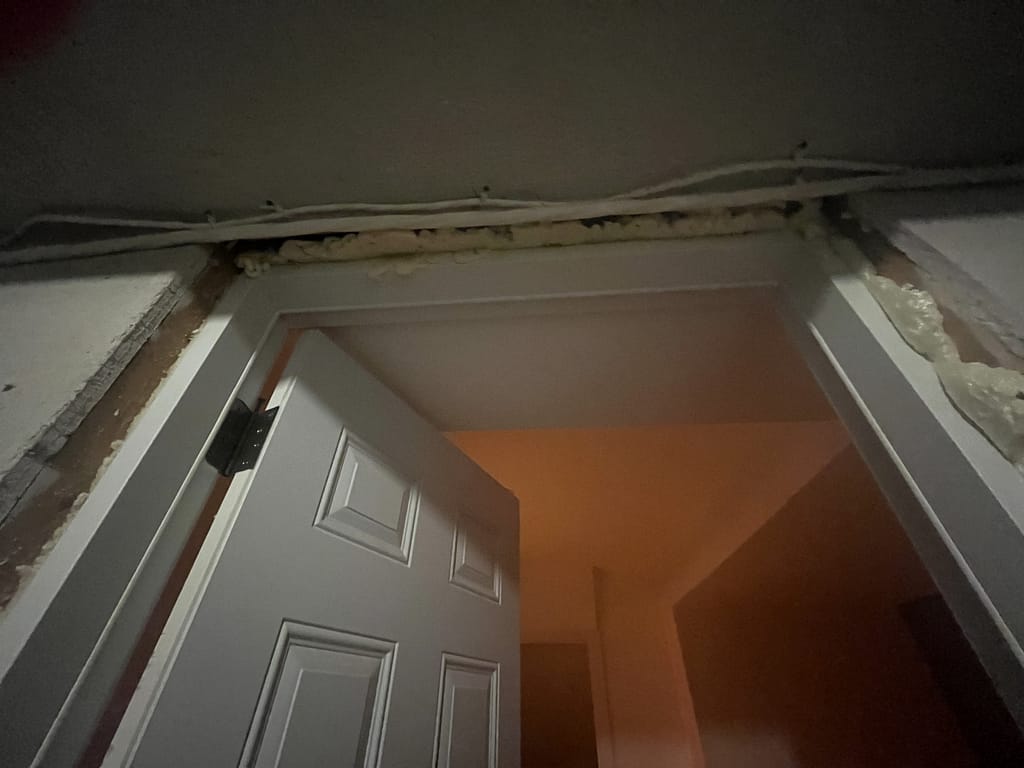 Exposed upper frame and wall conditions around the existing Burlington garage entry door