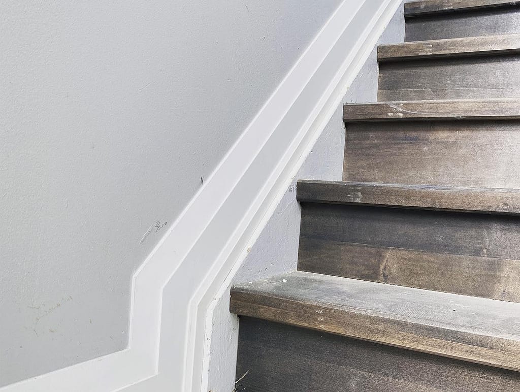 Baseboard and shoe moulding following a stair transition onto the finished floor