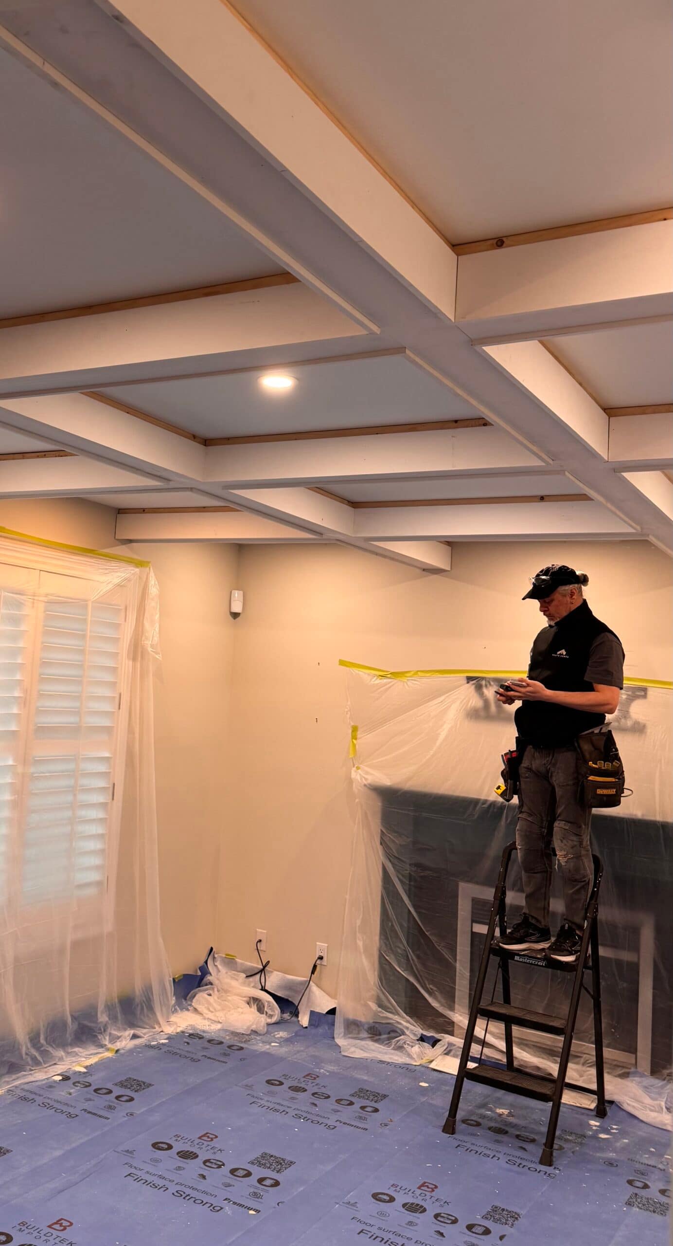Finish carpenter Jack Cenk Ozer at Wood Job Finish Carpentry is calculating coffered ceiling trim lengths.