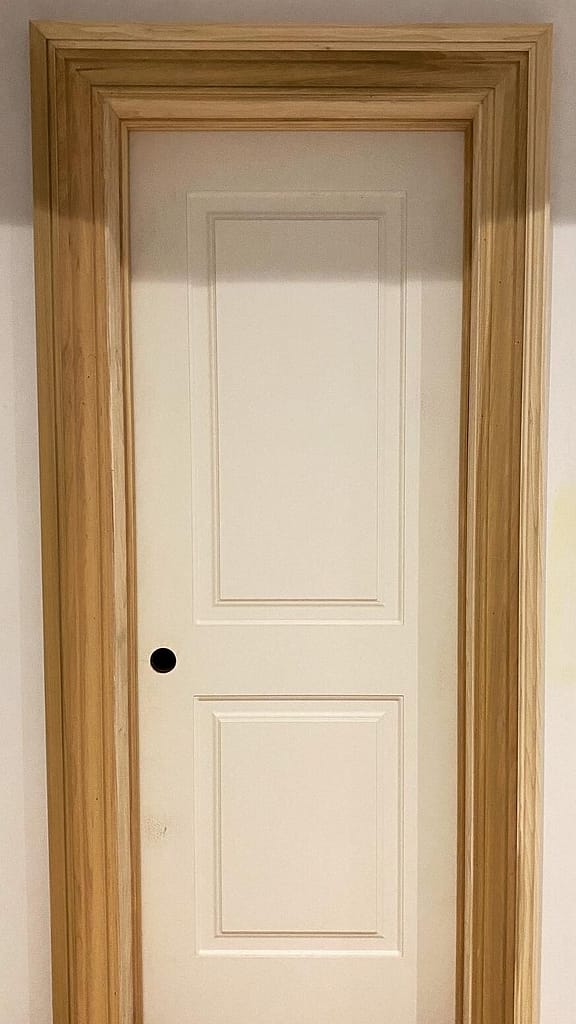 Wide four-and-a-half-inch poplar door casing finished with decorative backband