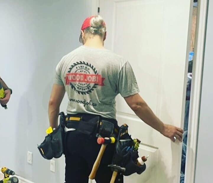 Finish carpenter installing an interior door