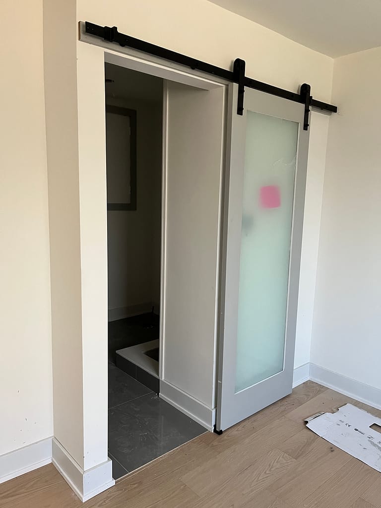 Interior barn door installation with smooth track operation