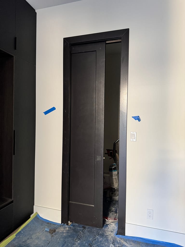 Custom pocket door installation with precise track and frame alignment