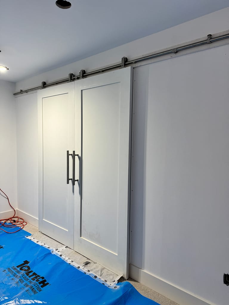 Space-saving sliding barn doors installed for a finished interior