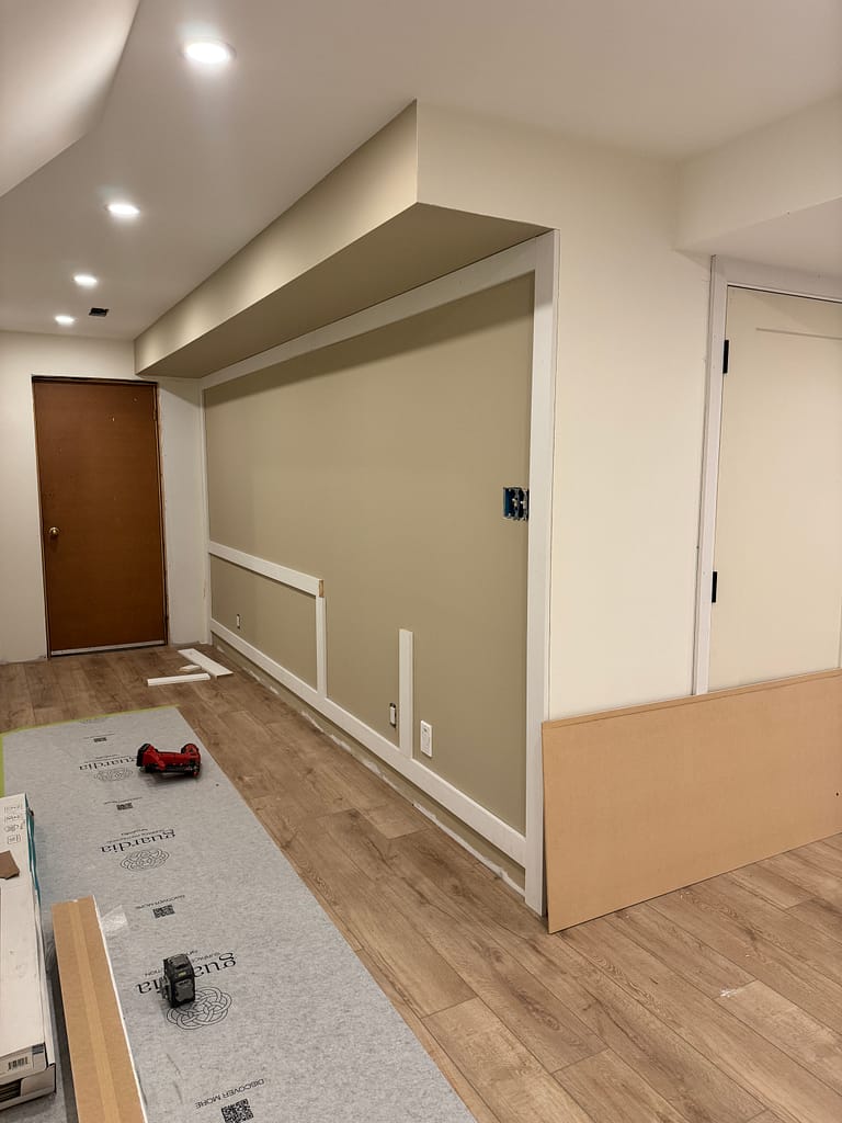 Board and batten wall layout preparation in a Milton basement before the full panel detail was completed.