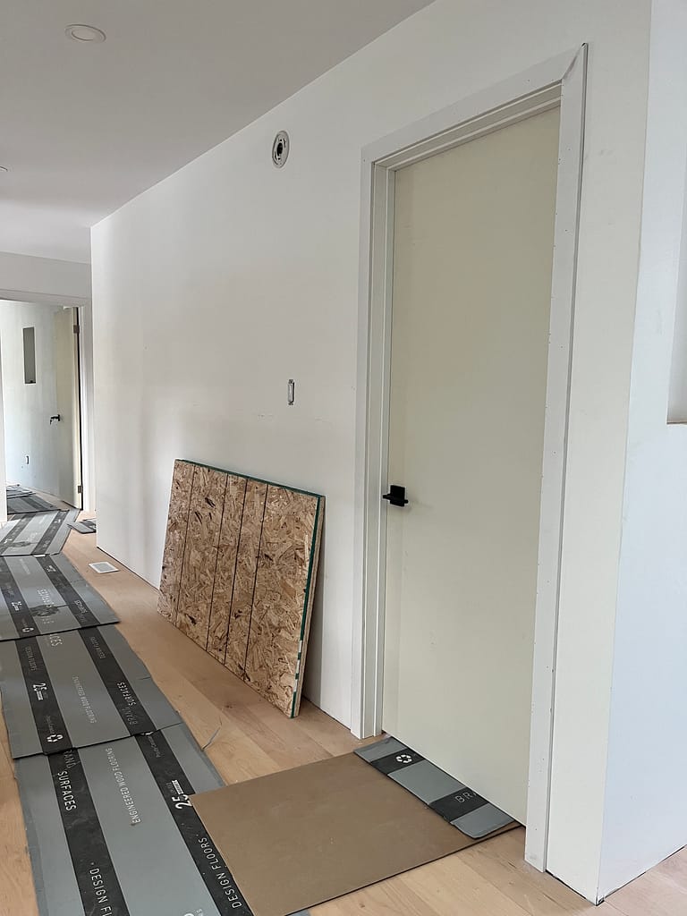 Lineup of freshly installed premium single-panel doors and modern trim finishes inside an Oakville custom estate.