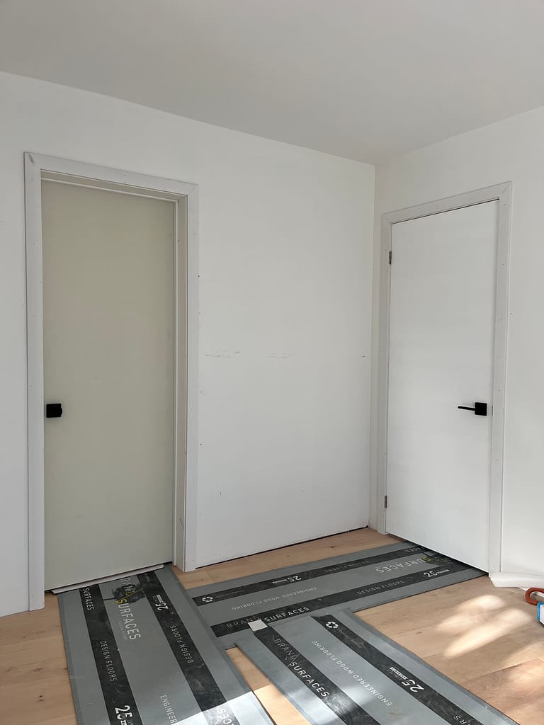 Precision mortised hinge recess with extended structural screws on a solid-core interior door slab.
