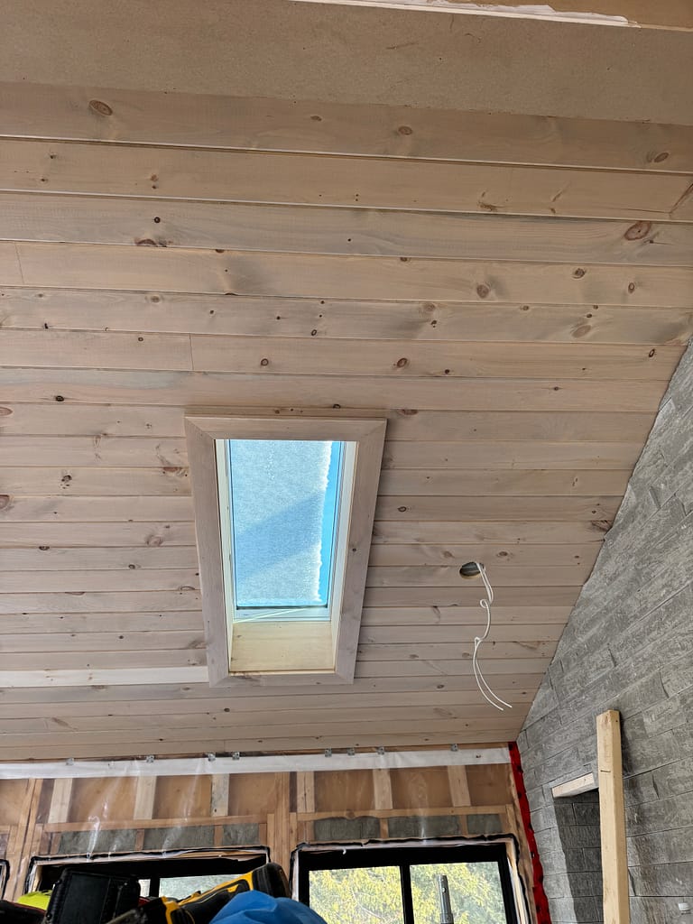 Shiplap ceiling and skylight trim inside an Oakville cabin-style room addition by Wood Job Finish Carpentry