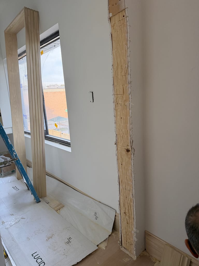 Rough opening after being widened for a tall interior door in a Toronto custom home