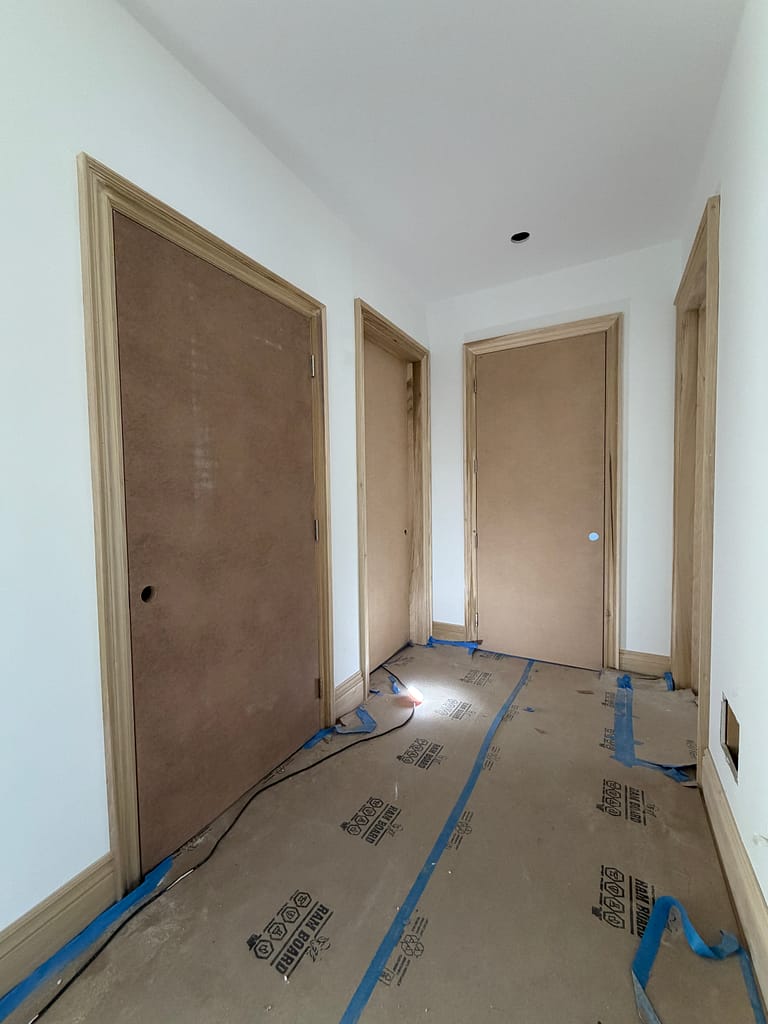 Multiple interior door openings with casing and baseboards in a Toronto custom home