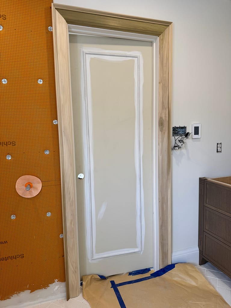 Custom interior door with applied molding after primer was applied over the new door detail.