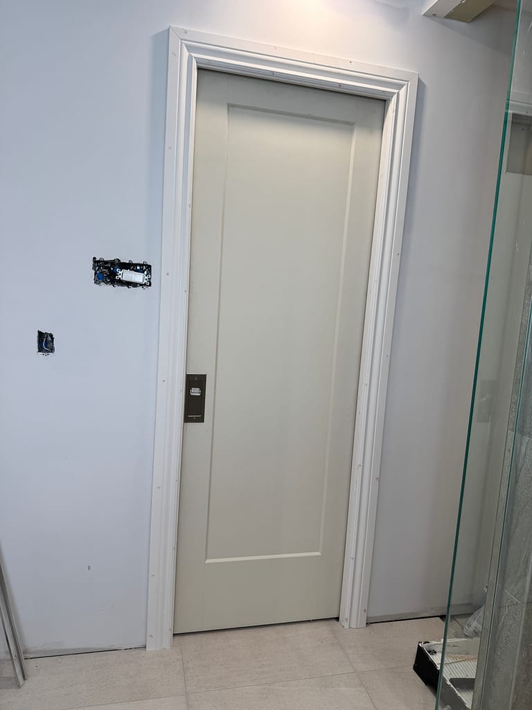 Closed pocket door with casing installed in an Oakville bathroom renovation