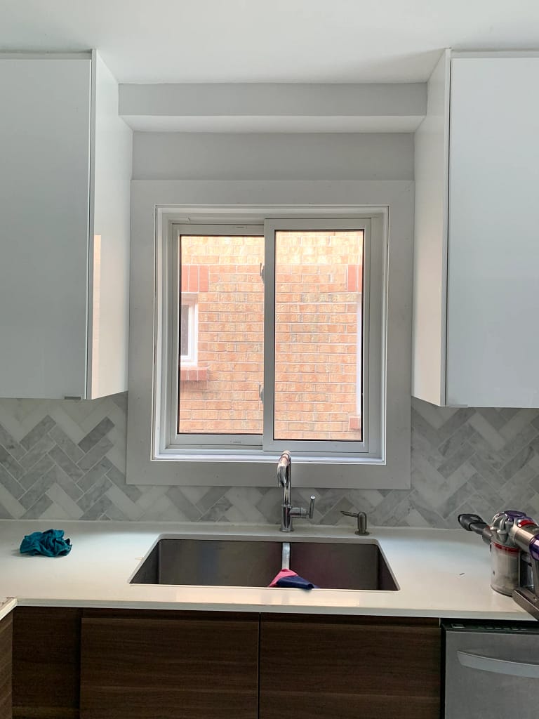 New white window casing installed above a kitchen sink in a Mississauga home