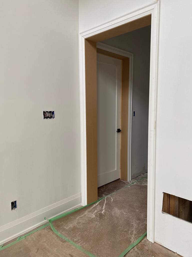 Door casing and baseboard transition during interior trim installation in Oakville