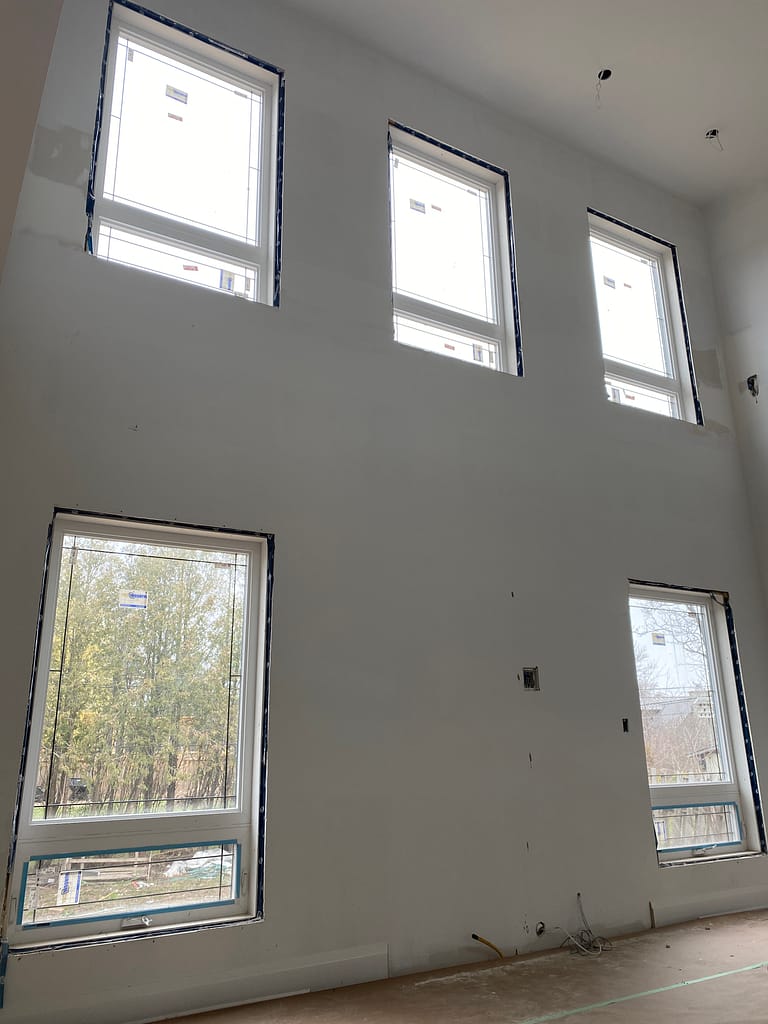 Tall window openings before interior trim installation in an Oakville custom home