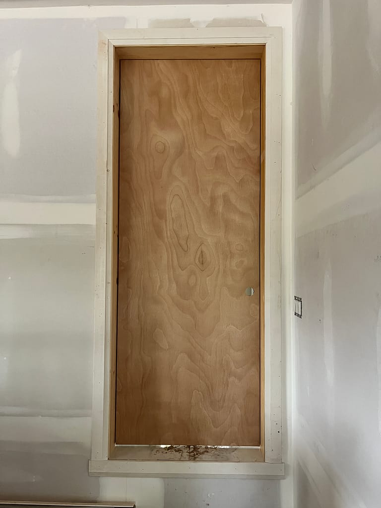 Fire-rated garage entry door installed with jamb and casing in an Oakville home.