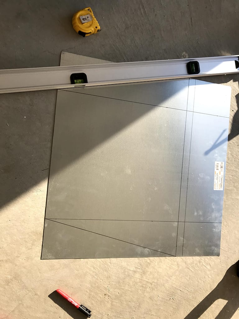 Sheet metal marked for a custom exterior wall vent snow guard roof in Mississauga