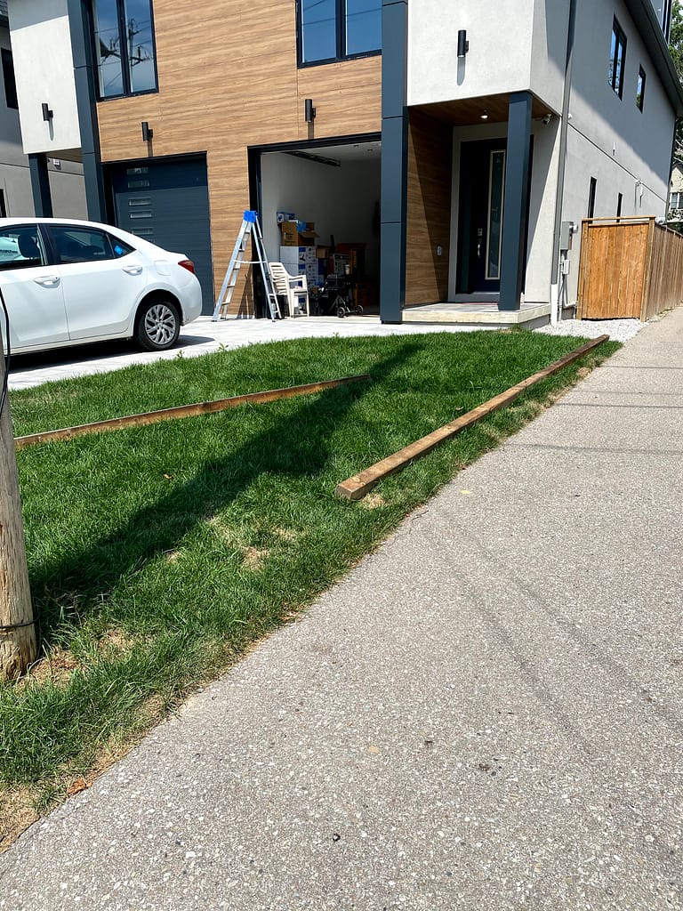 Pressure-treated timbers laid out for custom raised planter boxes in Mississauga