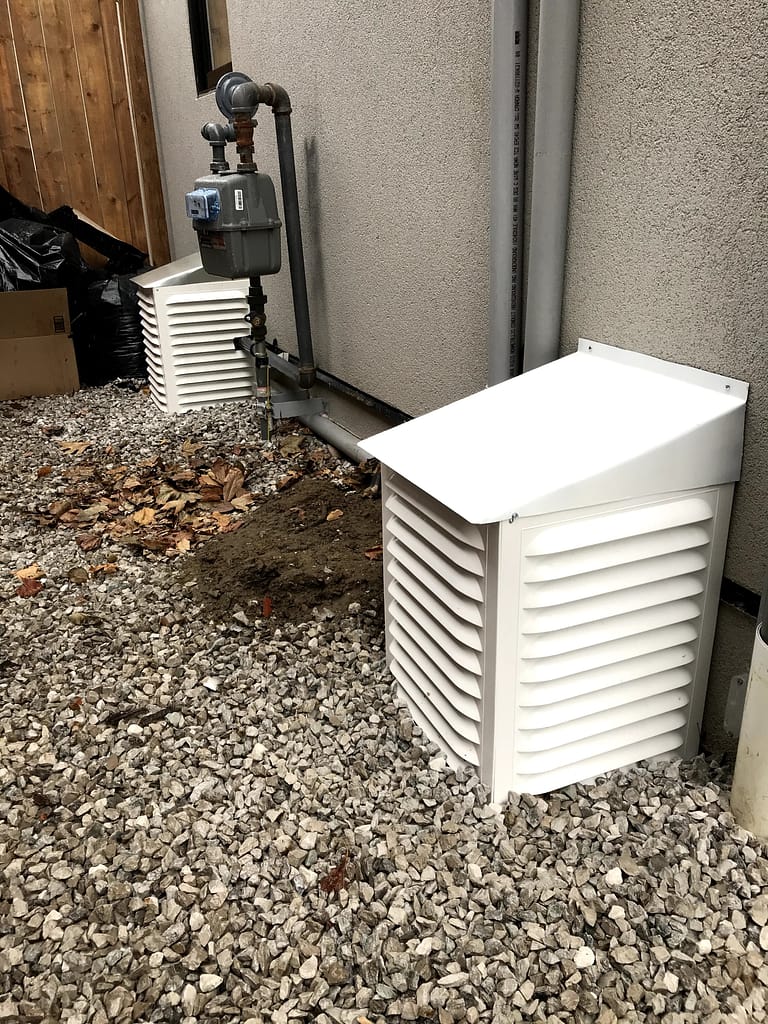 Completed exterior wall vent snow guards with sloped metal roofs in Mississauga