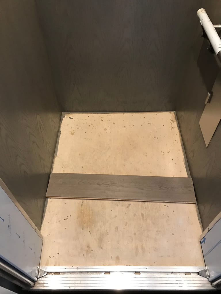 Engineered hardwood flooring being installed inside a residential elevator in Mississauga