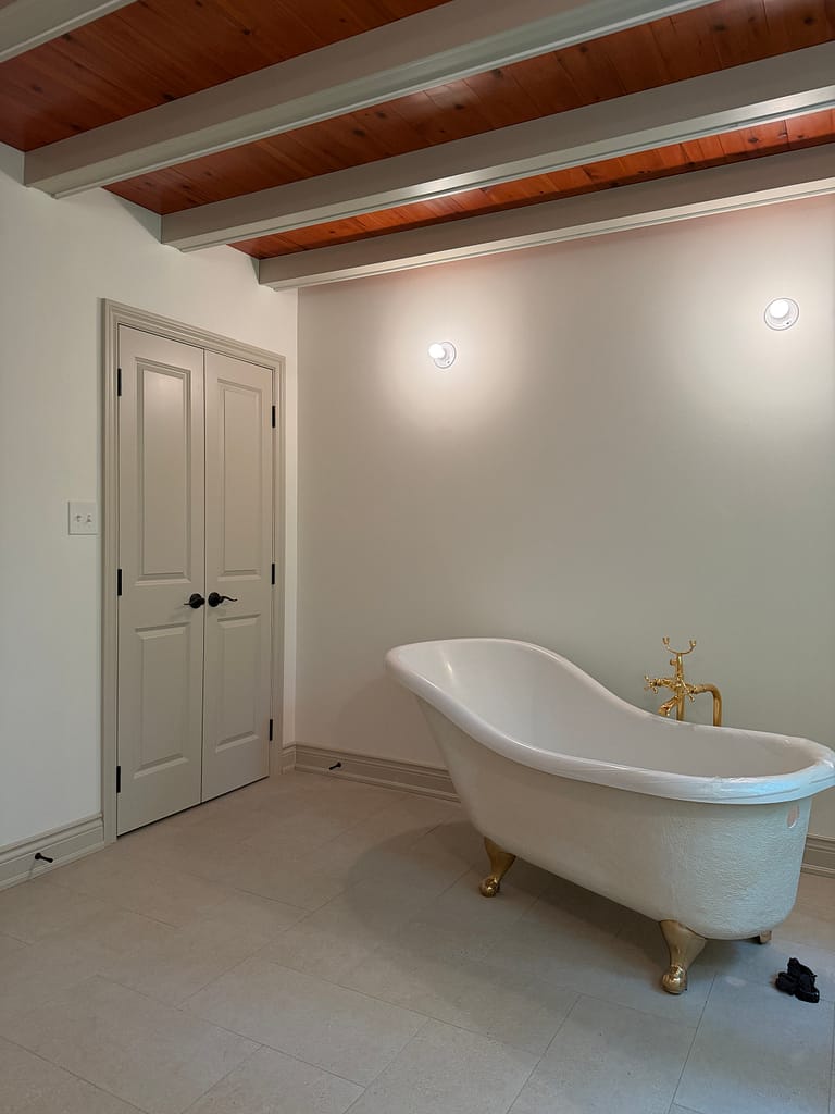 Finished Milton bathroom with double closet doors, custom beam covers, baseboards and traditional trim