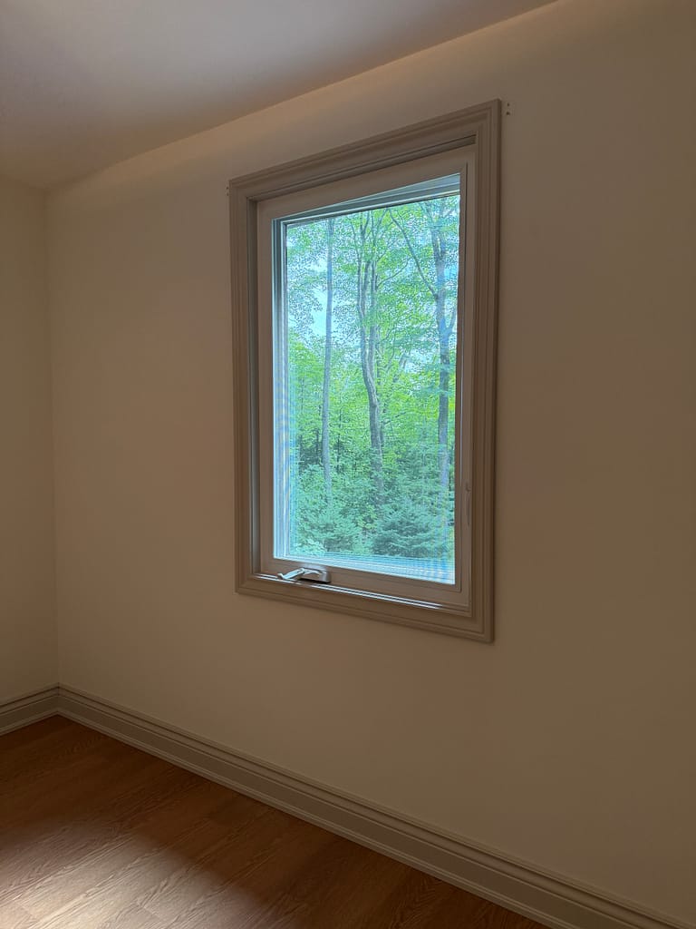 Custom window jamb extension and casing installed around a PVC window in Milton
