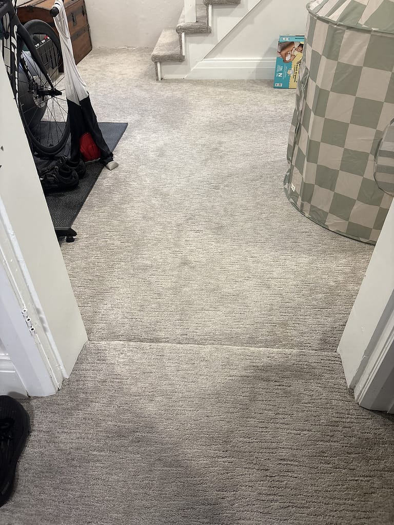 Raised carpeted threshold at a non-standard basement door opening in Kitchener