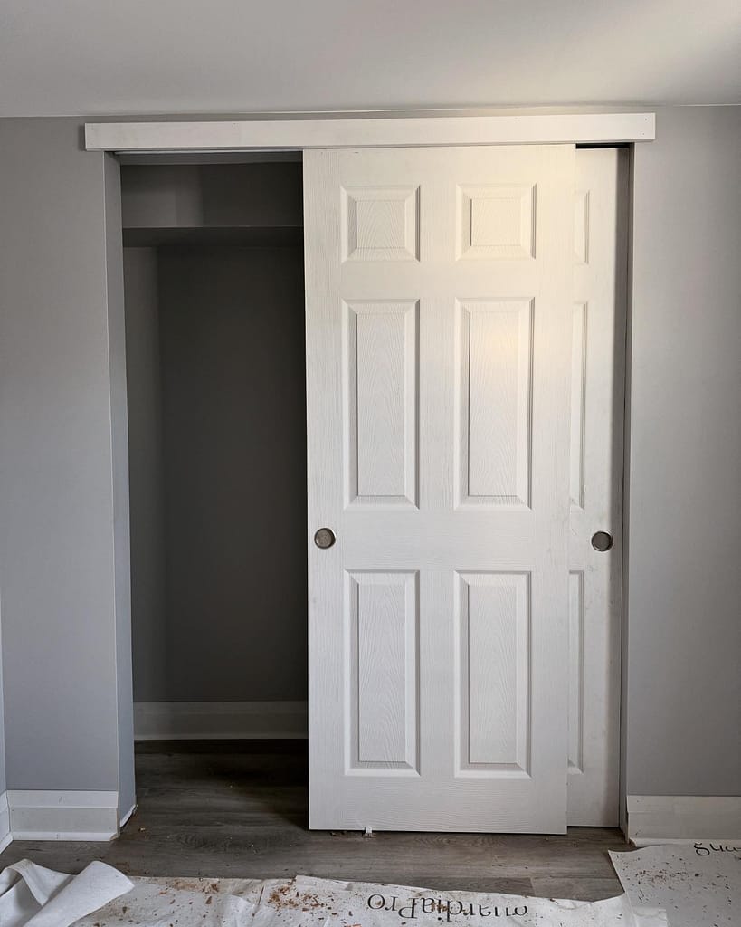 White sliding closet door installation with smooth track operation