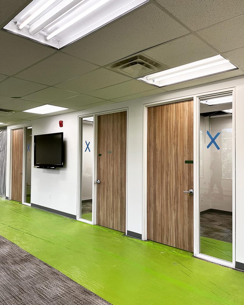 A hallway featuring a flawless lineup of professionally installed interior doors by a finish carpenter in Mississauga.