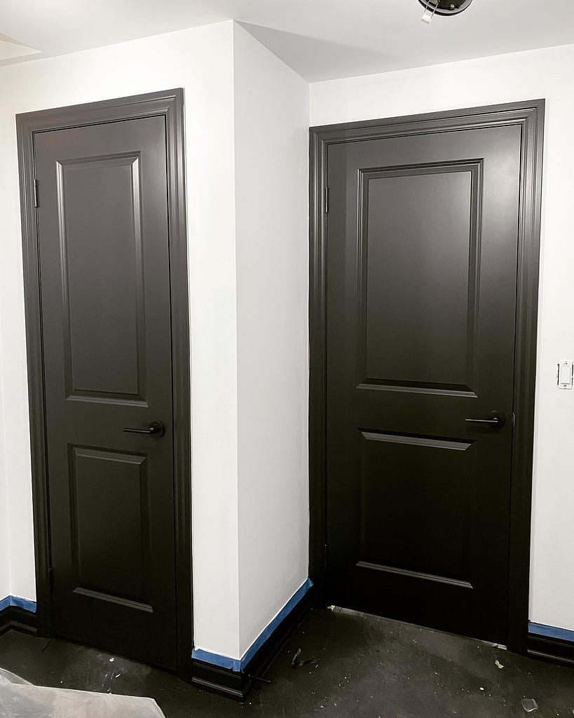 Two modern interior doors painted in deep black with custom architectural hardware installed by finish carpenter Jack Ozer in Vaughan.
