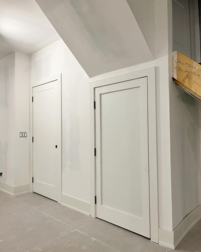 Custom-fitted slab door in a low Vaughan basement opening with MDF panel detail added to match nearby one-panel interior doors.