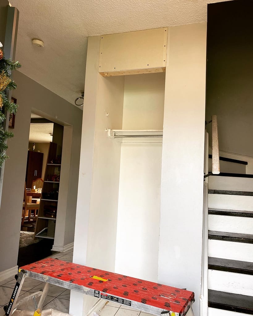 Resized closet opening with new framing and drywall above it during a hinged-door conversion in Milton
