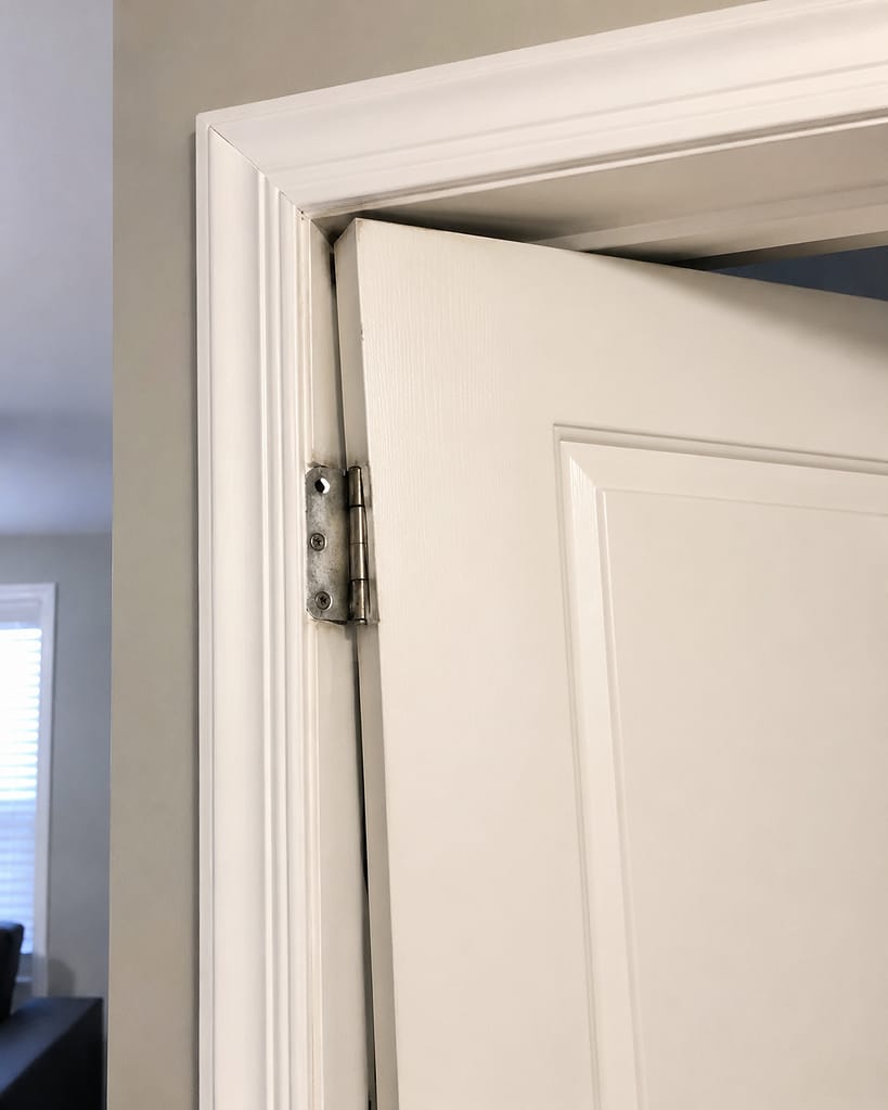 Interior door rubbing near the top jamb because the hinge side has shifted or the opening is out of alignment.