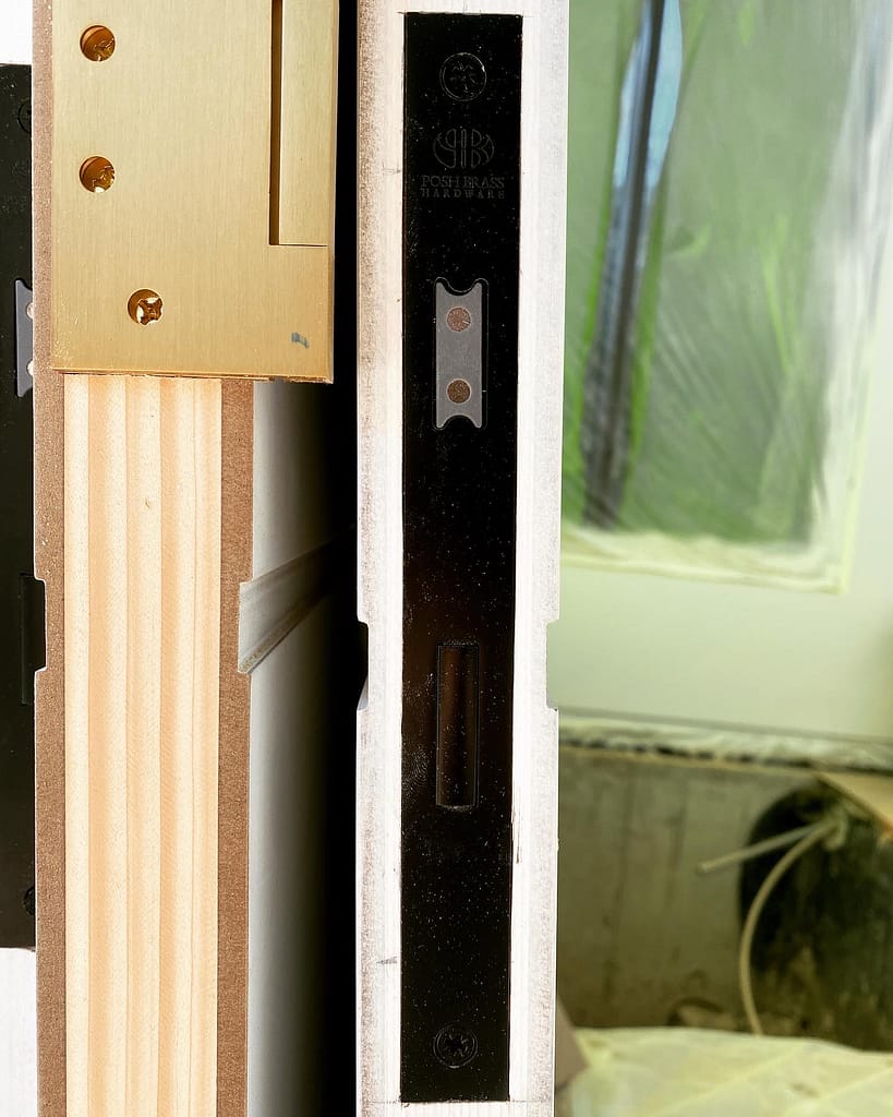 Close-up of a deep mortise prepared for European-style hardware inside the edge of a solid-core door.