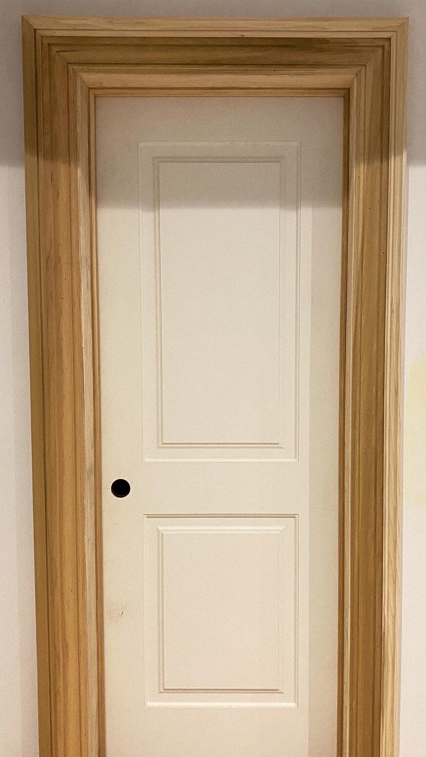 Clean trim and casing detail around an interior door installed by Wood Job Finish Carpentry