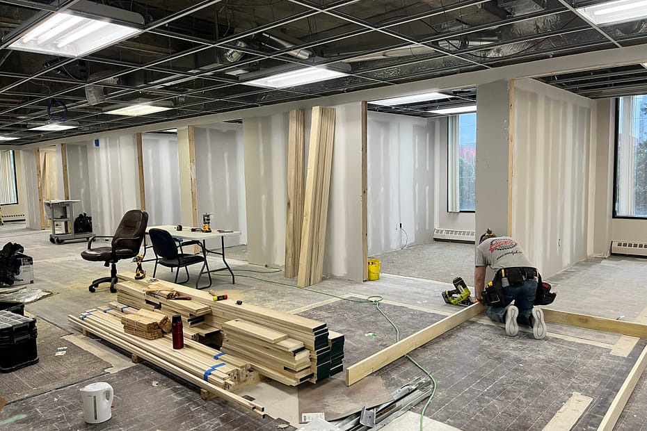 The master carpenter Jack Cenk Ozer is busy with installing a commercial door jamb