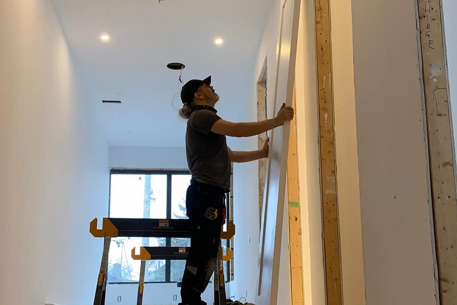 Jack Cenk Ozer working on a finish carpentry project inside a home