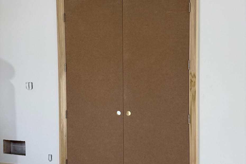Tall double interior doors with natural wood casing installed in a Toronto home