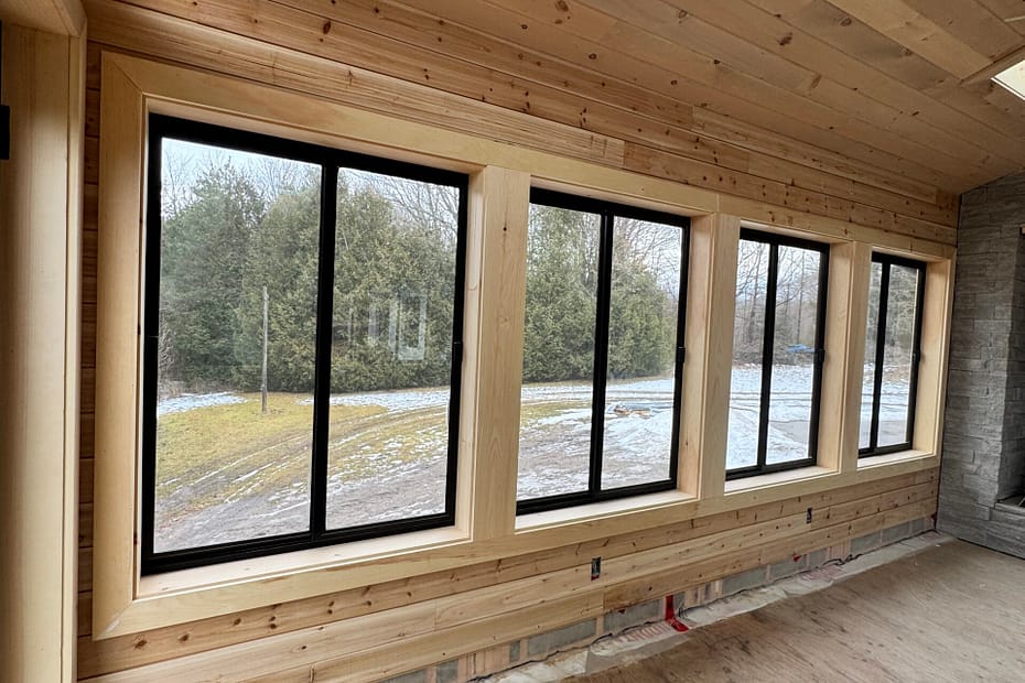 Wide window wall with natural shiplap interior and wood trim in an Oakville room addition
