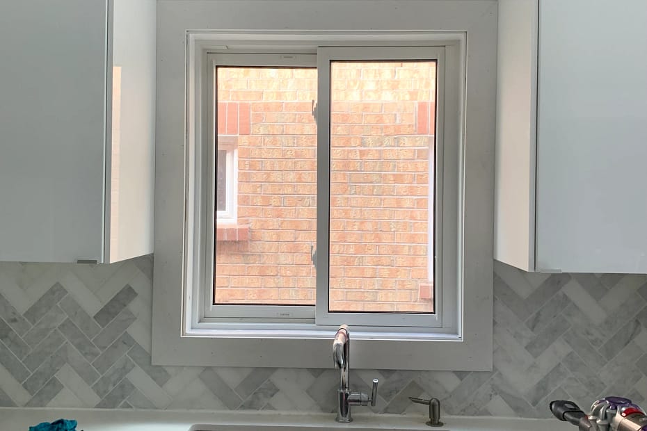 New white window casing installed above a kitchen sink in a Mississauga home