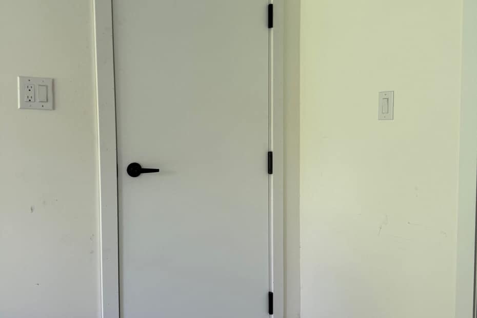 New flush fire-rated garage entry door with black hardware installed in Burlington