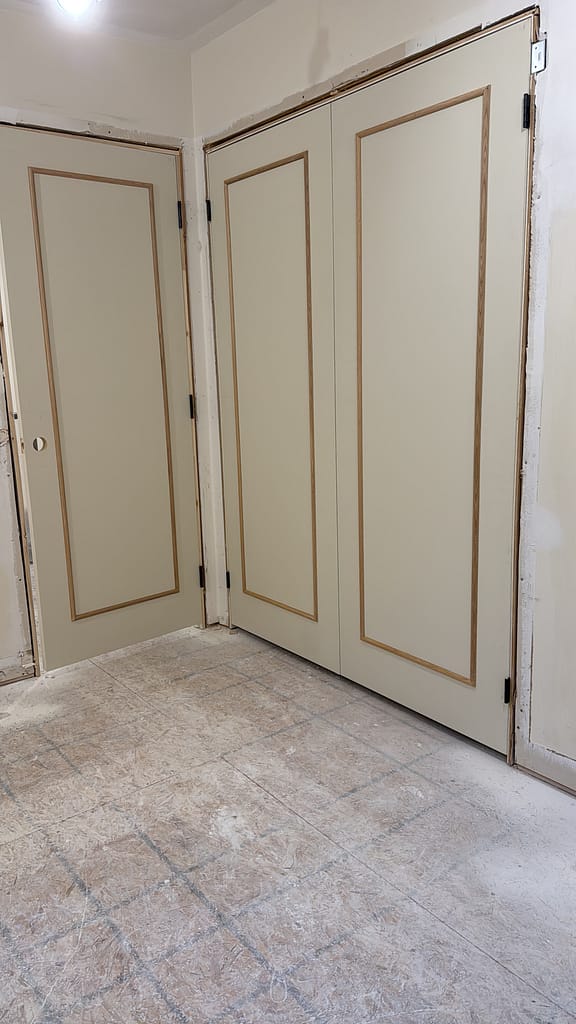 Plain slab interior doors customized with applied molding during a Vaughan finish carpentry project.