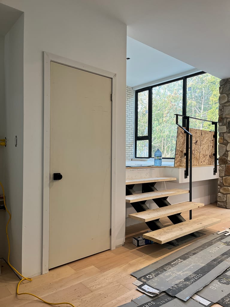 Heavy interior door perfectly squared and installed with precise reveals in an Oakville custom home build by Wood Job Finish Carpentry.