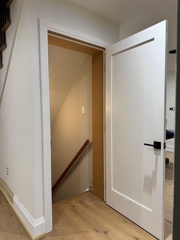 Scribed slab and customized jamb for interior door installation in Cambridge home.